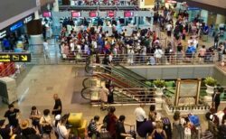 バンコクドンムアン空港で出国の手荷物検査を待つ観光客